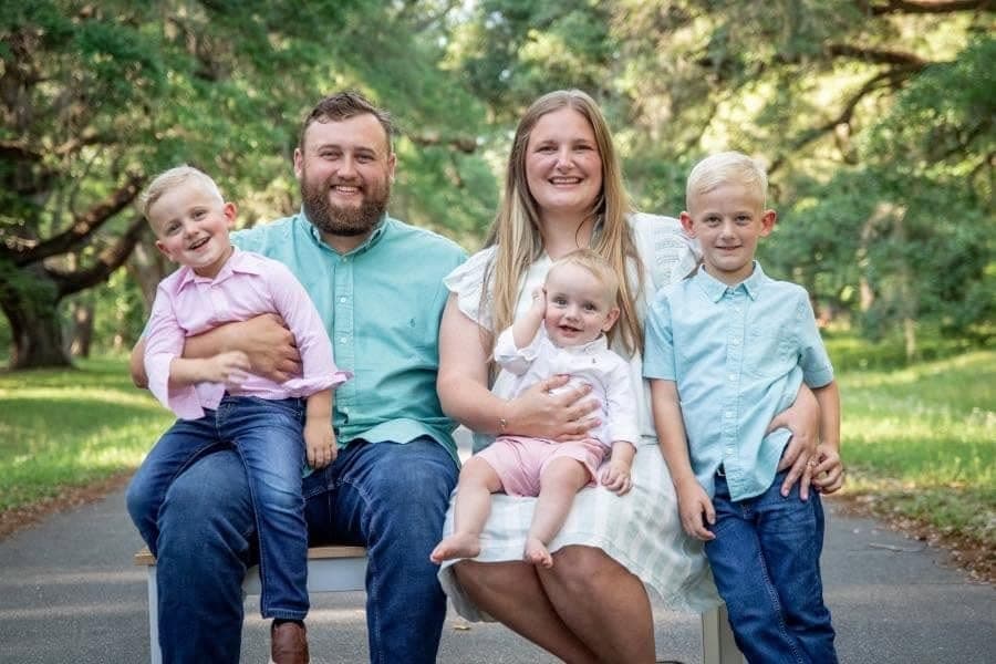 The Gallups family, owners of New Christendom Construction, photographed together outdoors in Milton, Florida