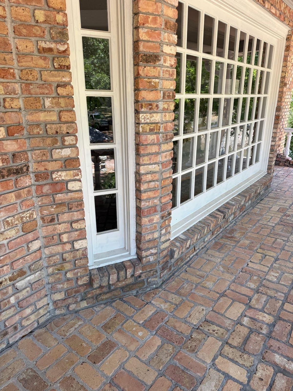The rebuilt sill seen along the full run of the bay window, joints matched to the original wall