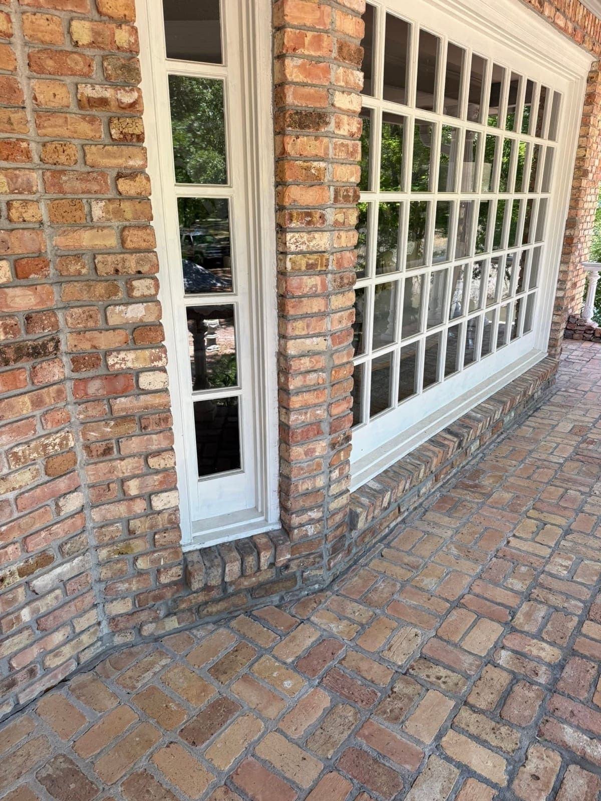 The same sill after rebuilding, with a tight matched brick course and tooled mortar joints