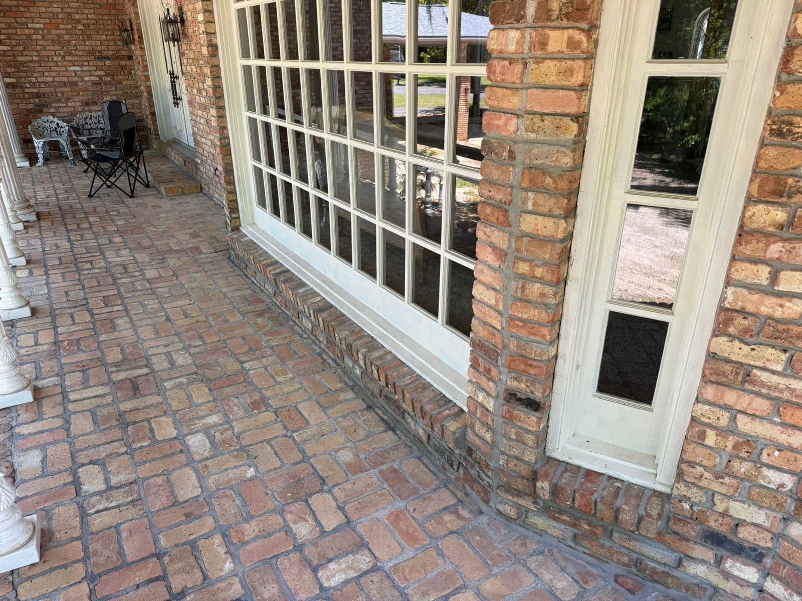 Finished masonry repair viewed along the covered brick porch