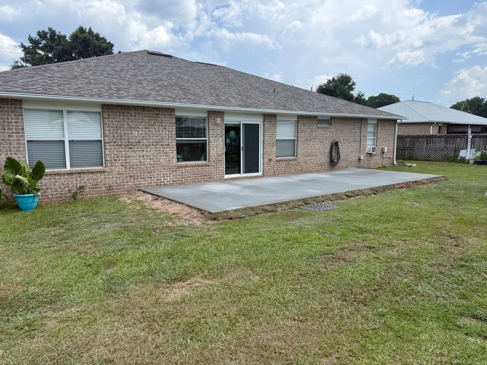 Wide view of the completed patio running the length of the rear elevation