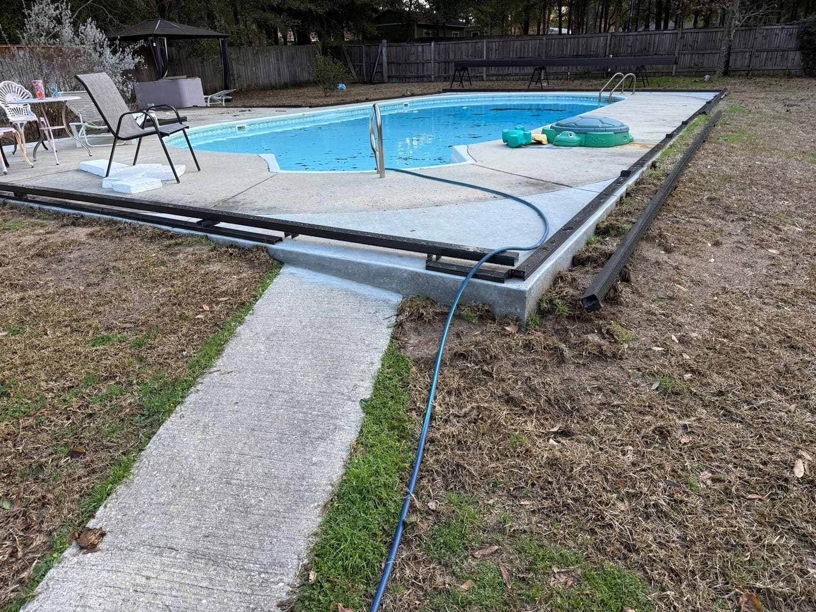 Wide view of the completed pool deck and the walkway leading to it