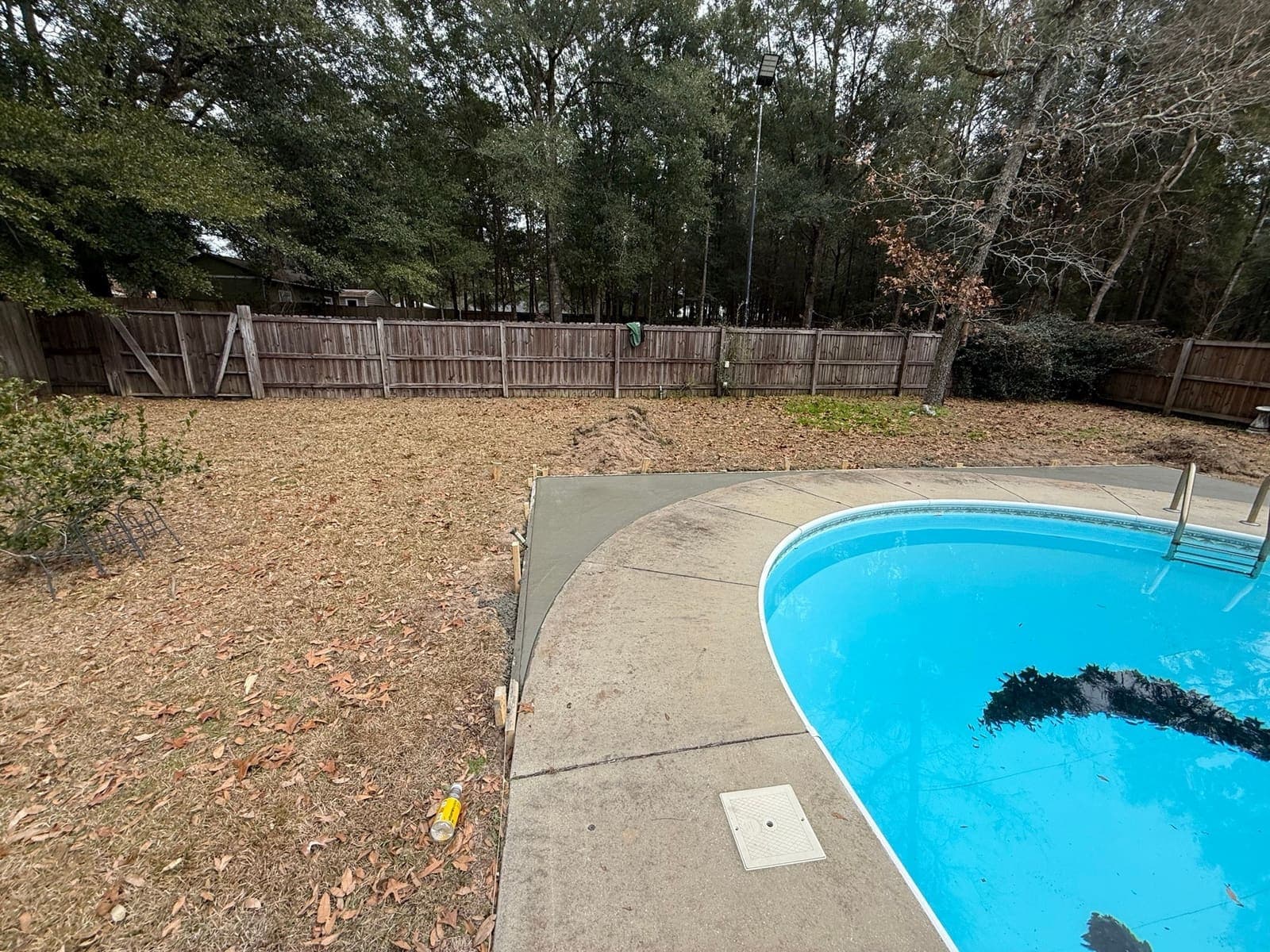 Finished deck edge curving around the end of the pool