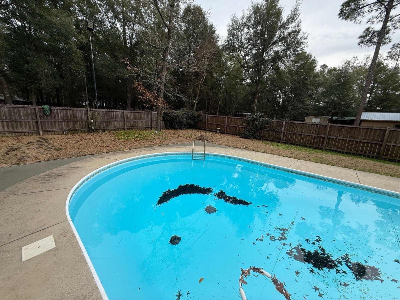 New concrete deck running the length of the pool