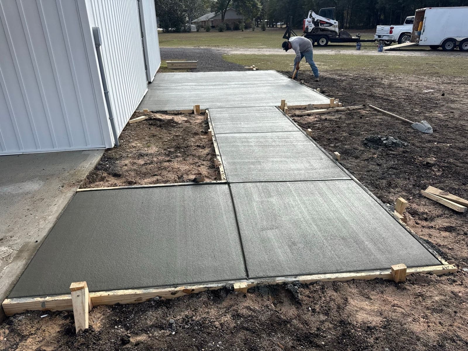 Finishing the poured walkway running along the side of the building